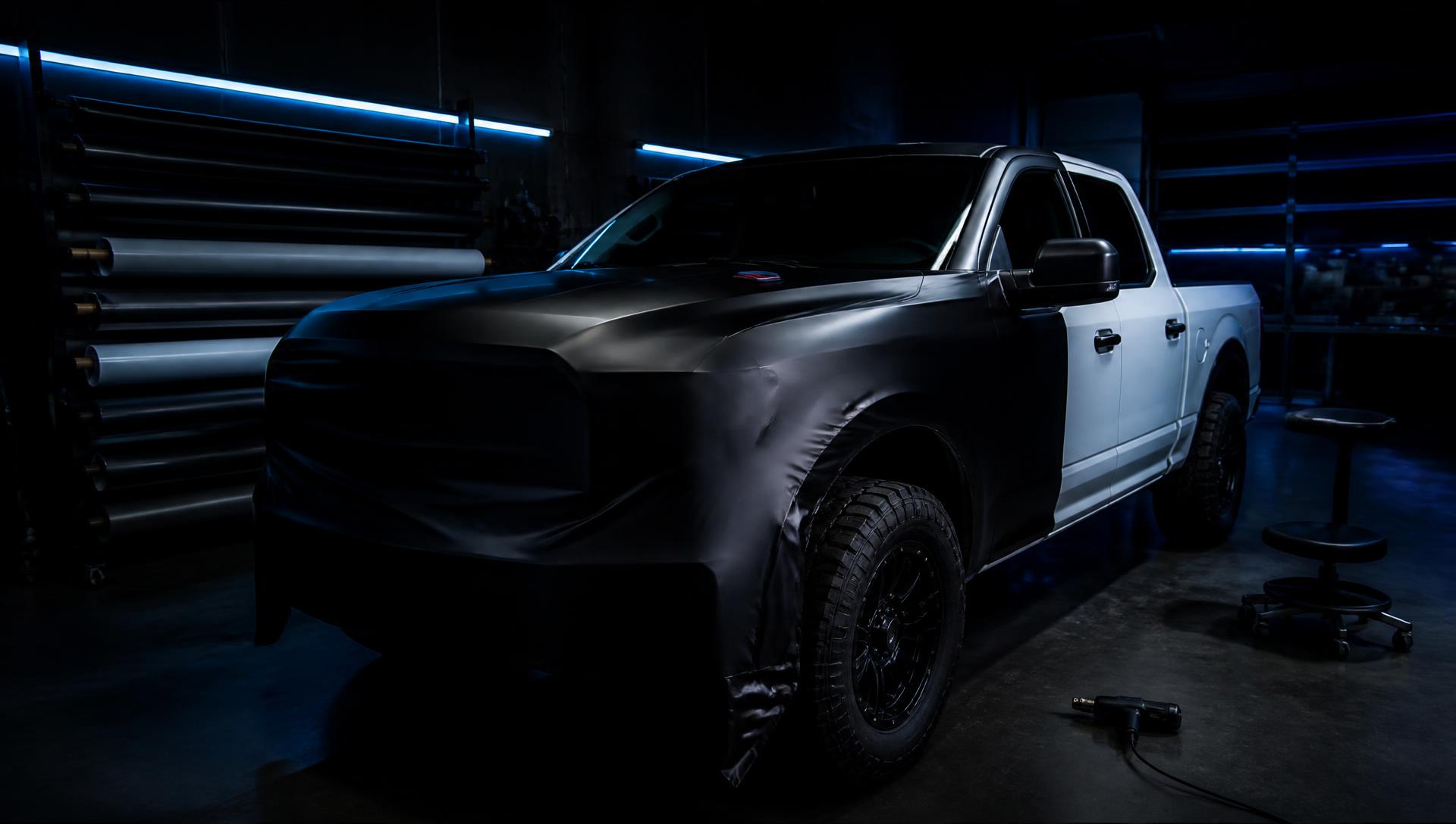 Pickup truck being wrapped in a professional vehicle bay